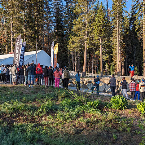 The handoff tent with a crowd gathered around to cheer on teammates as they begin and end their runs.